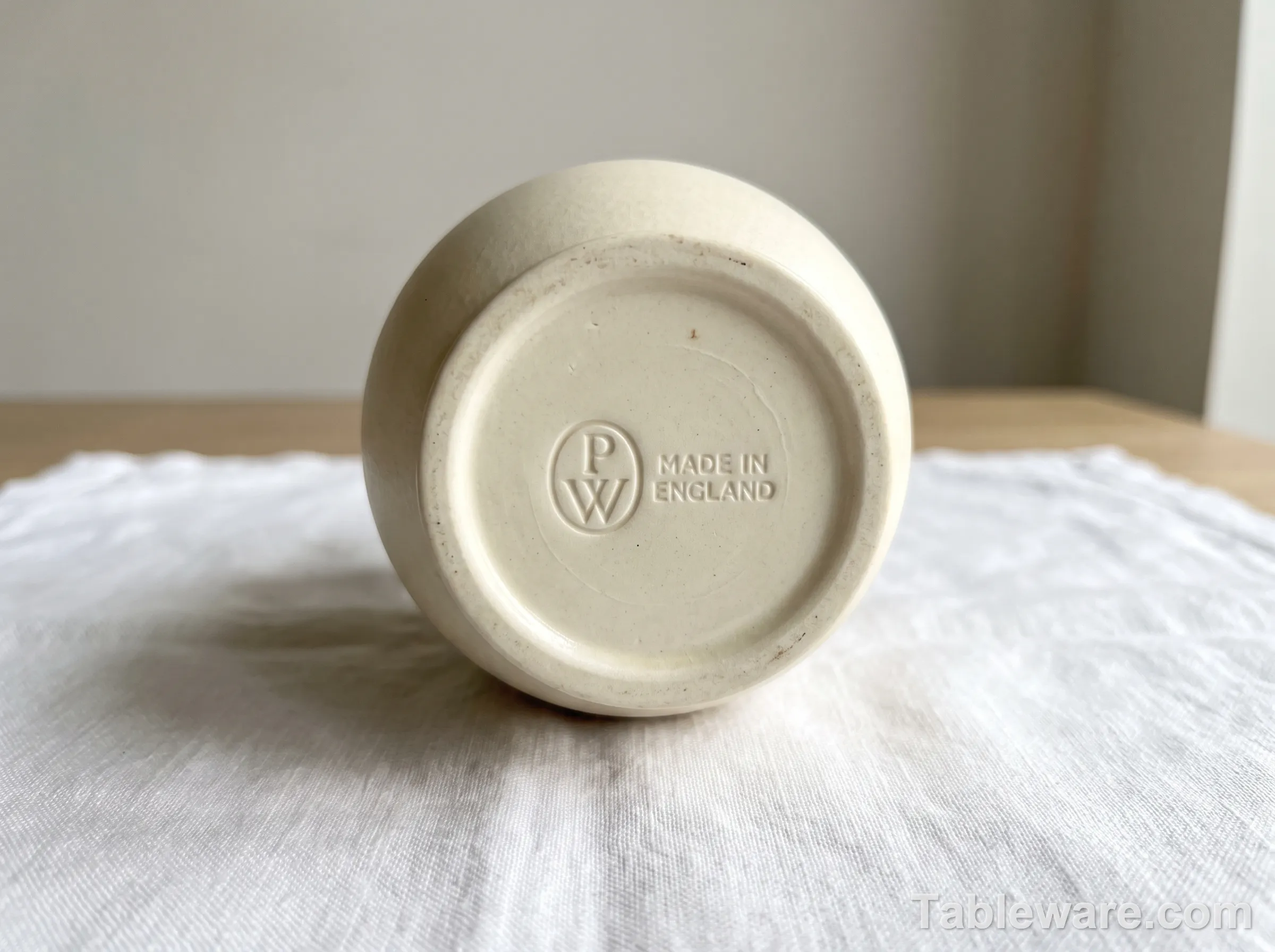 Close-up of a Wedgwood Portland Vase back stamp impressed into bone china, showing the three-letter Portland mark and 'Made in England'