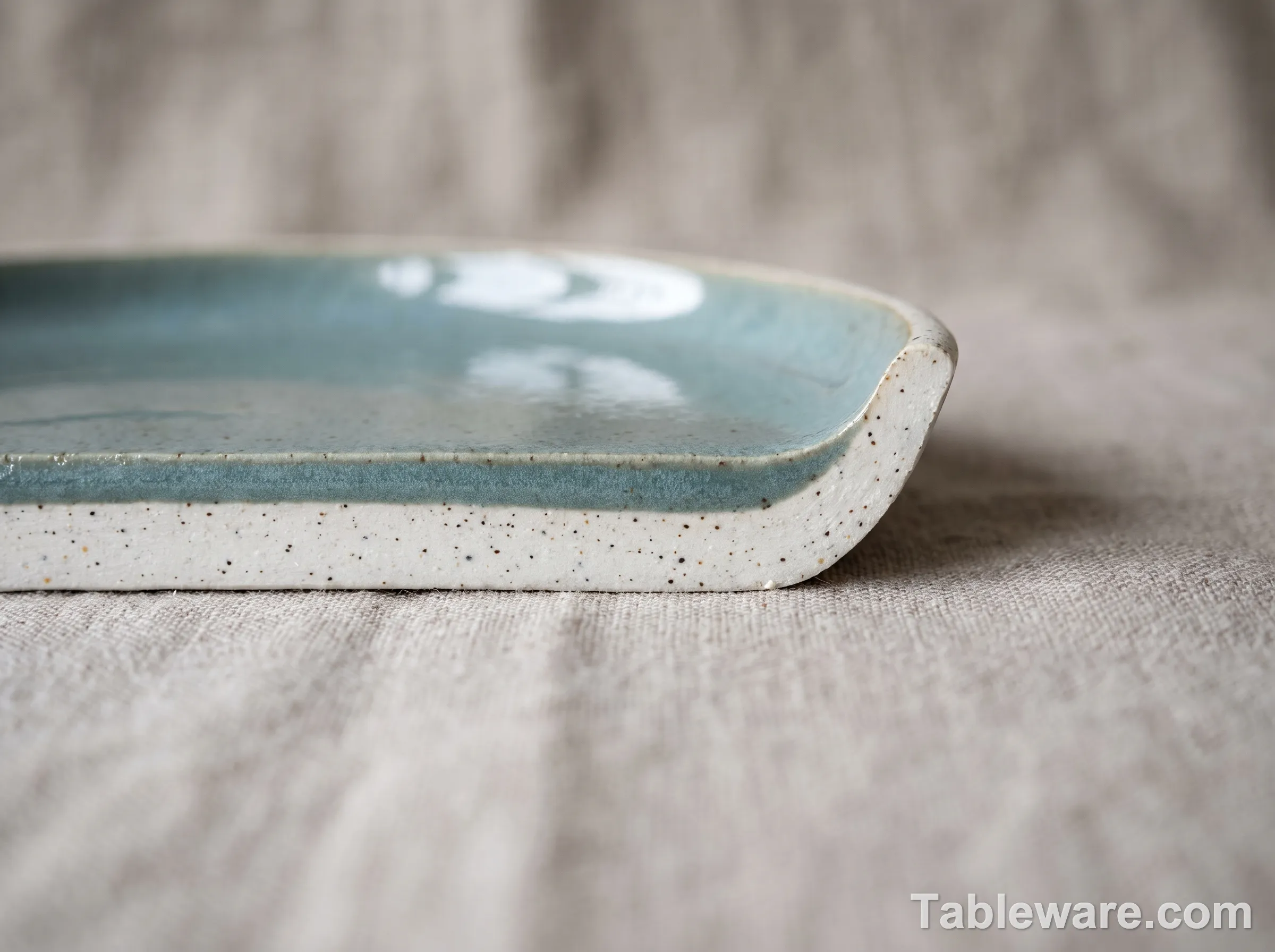 Cross-section illustration of a ceramic plate showing body, glaze layer, and food contact surface
